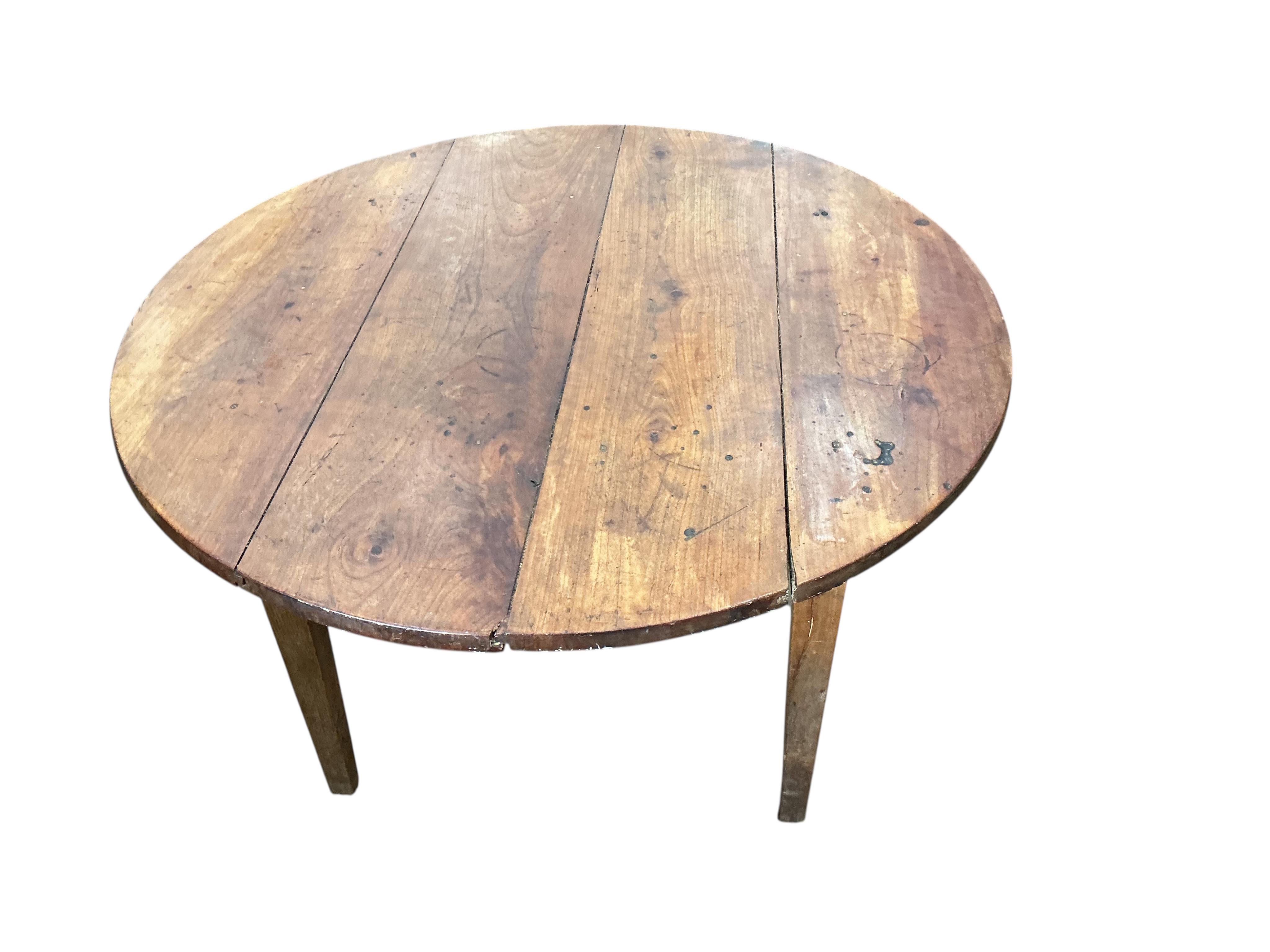 A 19th century French circular cherry kitchen table, diameter 113cm, height 74cm